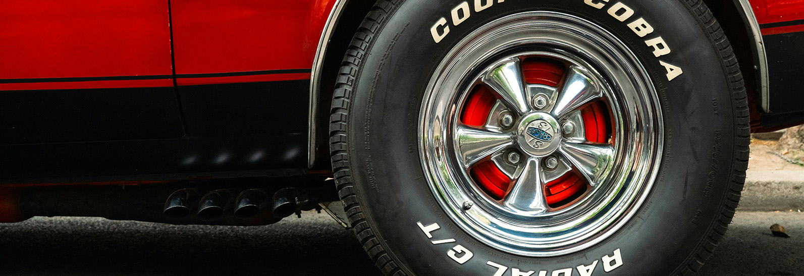 Detailed photo of a classic car's wheels.